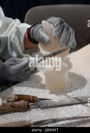 Working on alabaster sculpture. Stock Photo