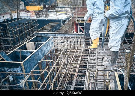 Workers compact concrete Stock Photo