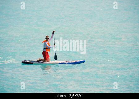 Man paddling on sup board Stock Photo
