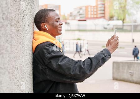 portrait of an African-American man making a video call with his smartphone in the city Stock Photo