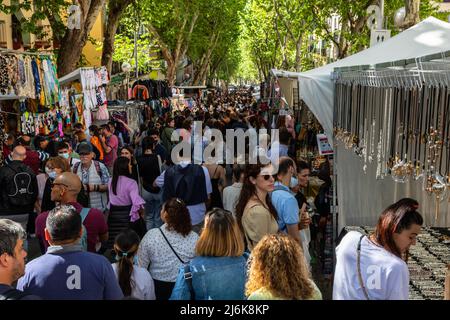 A typical crowded and vibrant Sunday view in Madrid of the open air flea market El Rastro. It is locatedbetween Calle Embajadores and Toledo gate Stock Photo