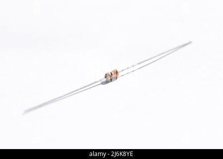 A portrait of a 330 ohm resistor with a 5% tolerance. The electric component is isolated on a white background and is ready to be used in an electroni Stock Photo