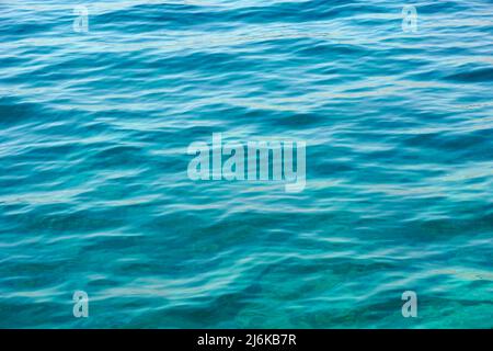 Beautiful abstract background with transparent turquoise surface of shallow sea water waving
