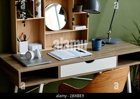 Background image of students workplace with wooden table and notebook set up for home education and studying Stock Photo