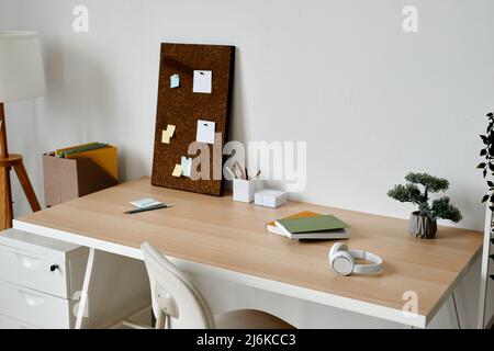 Background of white home office workplace with bonsai tree on desk, copy space Stock Photo