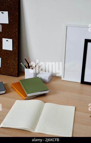 Vertical background image of simple students workplace with opened notebook on desk, copy space Stock Photo