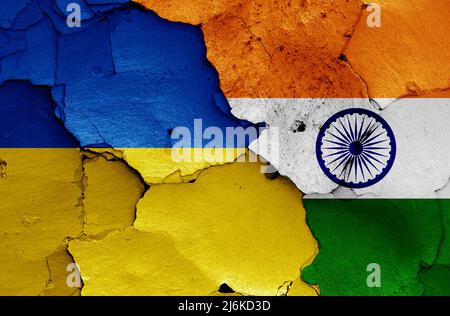 flags of Ukraine and India painted on cracked wall Stock Photo