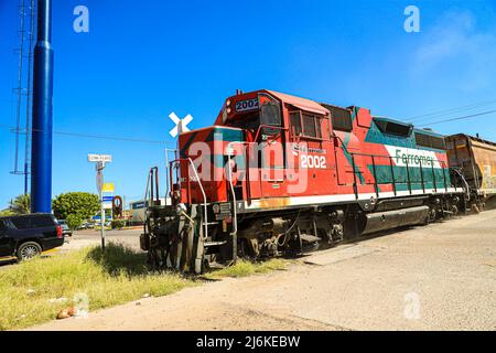 Feromex company train passing through Navojoa, Sonora Mexico. Mexican transport, Mexican railways, the largest railway network in Mexico with 11,000 km of track, covering the main industrial and consumer areas of the country. Stock Photo