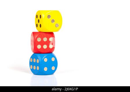 Three simple colorful game dice stacked on top of each other, unstable built structure, business strategy plan, numbers, luck, education concept, copy Stock Photo