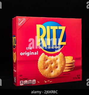 A bright red box of the original Ritz Crackers by Nabisco, isolated on black Stock Photo