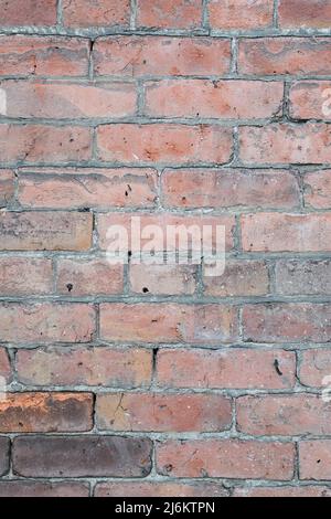 Weathered brick wall with irregular pattern of brickwork and worns bricks Stock Photo