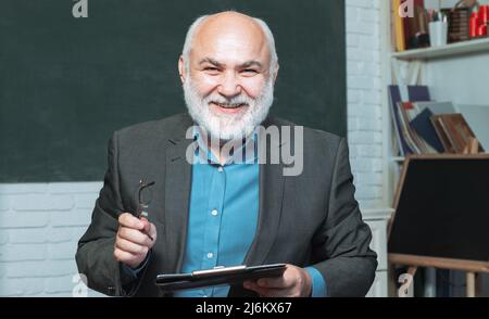 Good teachers enjoy teaching. Bearded professor at school lesson at ...