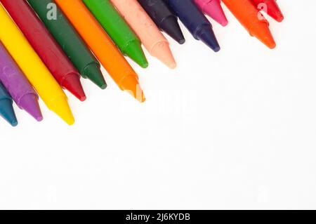Multi colored crayons, unwrapped, no wrappers, isolated on white with copy space. Great for web page, signage background, flyers and more. Stock Photo