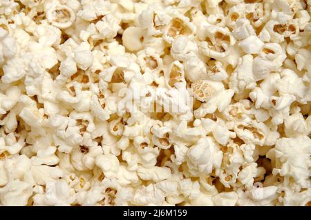 Close up of popped popcorn, covering the photo surface as could be used for a background or flyer. Stock Photo