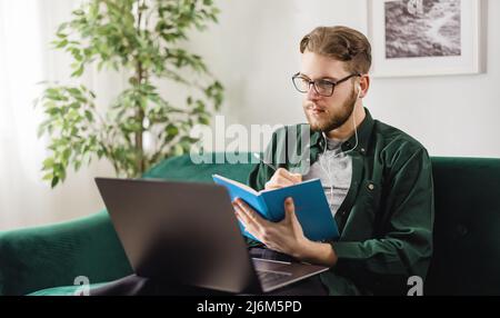 Man using laptop for studying Stock Photo
