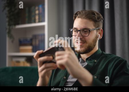 Man playing games on smartphone Stock Photo