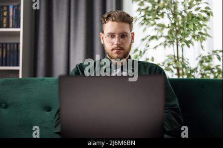 Man with laptop at home Stock Photo