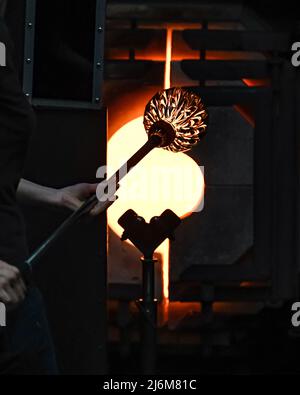 Glass blowing - a glass kiln furnace - glory hole - used in making glass art at the Corning Museum of Glass Stock Photo