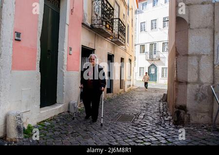 An elderly woman seen walking through the streets belonging to the Santa Apolonia neighborhood in Lisbon. Cases of covid-19 decreased in Portugal after a week of a slight increase. The number of new cases of the virus and the incidence has fallen again, according to the DSG ( General Health Direction) report, which highlights the increase in the circulation of the BA.5 strain of the Omicron variant and a new sub-strain of BA.2. Stock Photo