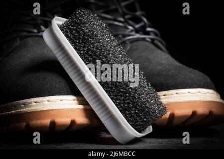Close up of black hard foam sponge for suede shoes. Stock Photo