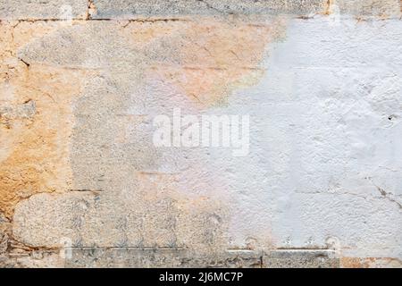 Old gray color stone block wall texture background. Aged faded industrial construction, front close up view Stock Photo