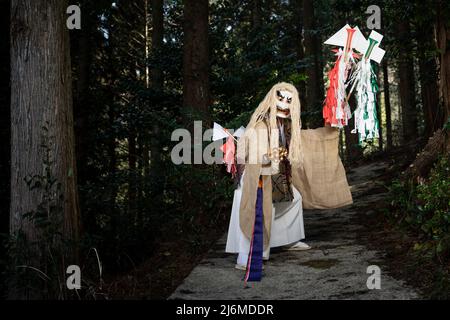 Fujisaki-san, a master of Kagura the Shinto ritual performance telling the stoires of the gods. Wearing the white mask to perform The Dance of Tajikar Stock Photo