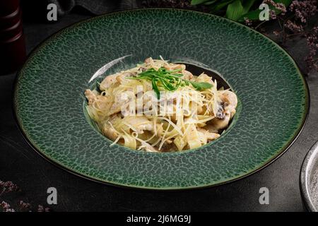 Creamy tagliatelle with chicken and mushrooms Stock Photo