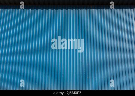 Blue fence. Fence made of profile sheet. Metal fence. Stock Photo