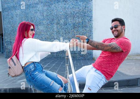 young couple holding hands having fun Stock Photo