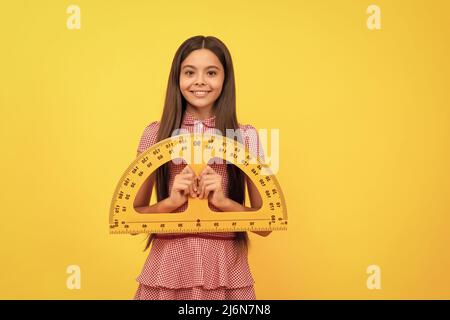 cheerful teen girl study math in school hold protractor ruler, geometry Stock Photo