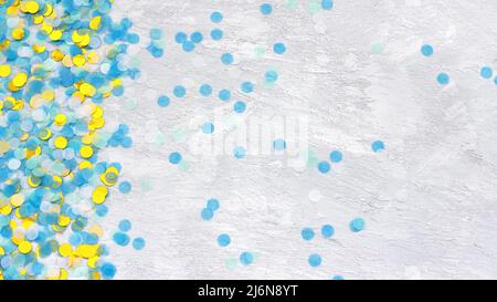 Colorful confetti on light gray background, top view, horizontal Stock Photo