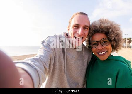selfie of a happy young couple smiling funny, concept of friendship and fun in a relationship, copy space for text Stock Photo