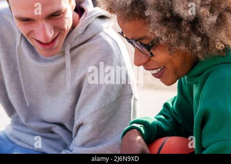 close-up portrait of a young latin woman smiling with a caucasian friend, concept of lifestyle and friendship Stock Photo