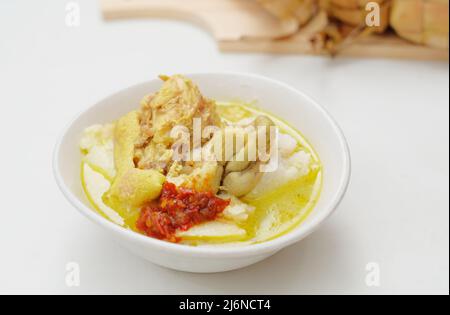 Opor Ayam is served on a white background. Opor is a traditional Indonesian food made from chicken cooked with coconut milk sauce Stock Photo