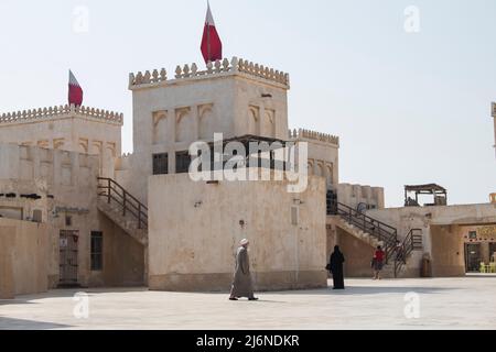 Doha ,Qatar - February 01,2020 : New souk Al Wakrah waterfront promenade with his traditional houses and local people enjoying walking. Stock Photo