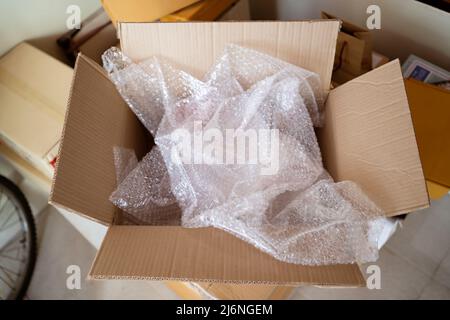 An opened cardboard box with bubble wrap inside Stock Photo