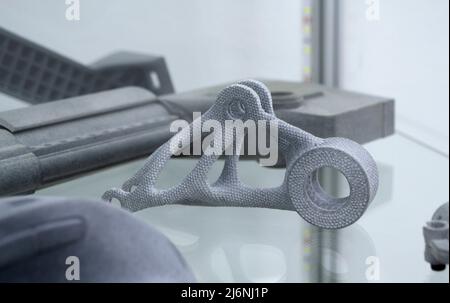 Many different models printed on 3D printer. Gray objects printed on 3D printer Stock Photo