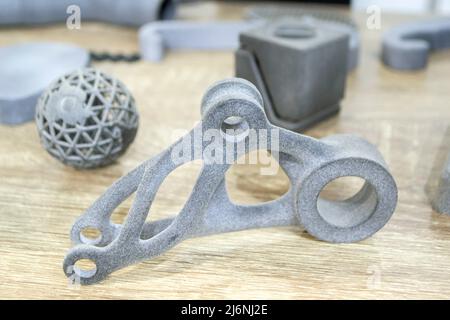 Many different models printed on 3D printer. Gray objects printed on 3D printer Stock Photo