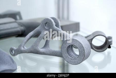Many different models printed on 3D printer. Gray objects printed on 3D printer Stock Photo