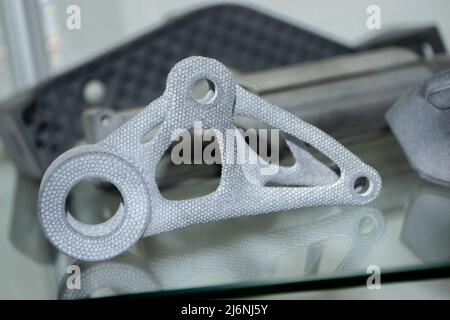Many different models printed on 3D printer. Gray objects printed on 3D printer Stock Photo