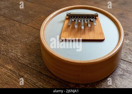 Sansula or kalimba instrument with membrane on a wooden floor ...