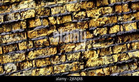 Big full background of detailed old dark yellow brick wall  Stock Photo