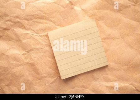 a sticky note on crumpled paper  Stock Photo