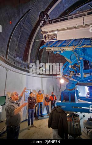 Visitors to the Pic du Midi Observatory near Bagneres de Bigorre, France, are given an explanation about the workings of the multiple Coronagraph. Stock Photo