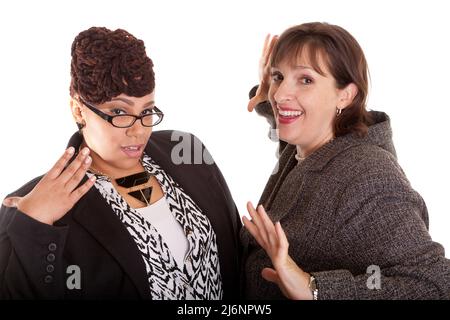 Two confident plus size mixed race business women on a white background in a happy or silly pose part of a series Stock Photo