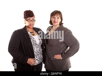 Two confident plus size mixed race business women on a white background in a serious confident pose part of a series Stock Photo