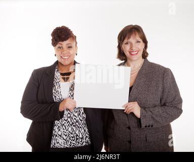 Two confident plus size mixed race business women on a white background in a happy or silly pose part of a series Stock Photo