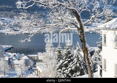 Room with a view to the fjord and little town Ørsta not far from Ålesund after snow fall in early April 2022 creating special light Stock Photo