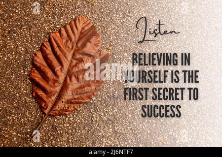 Motivational and inspirational quote - Believing in yourself is the first secret of success. With dry leaf background. Stock Photo