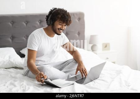 Young indian man student attending webinar from home, e-education Stock Photo
